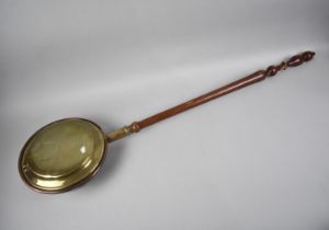 A Vintage Bed Warming Pan with Turned Wooden Handle