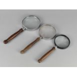 A Collection of Three Wooden Handled Desktop Magnifying Glasses, Largest 23.5cms