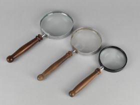 A Collection of Three Wooden Handled Desktop Magnifying Glasses, Largest 23.5cms