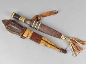 Two Tribal Daggers with Wooden Handles and Leather Scabbards ,