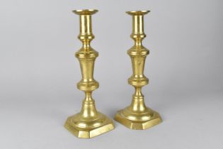 A Pair of 19th Century Brass Candlesticks with Pushers, 27cm high