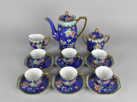 A Noritake Coffee Set Hand Painted with Flowers on Blue Ground to Comprise Coffee Pot, Six Coffee