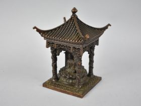 A Far Eastern Bronze Study of a Pagoda Temple with Three Seated Buddhas, 10cm Square and 14.5cm High