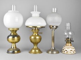 A Collection of Four Various Oil Lamps to Include Two Brass Based, One Silver Plate Based and One