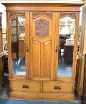 A Late Victorian/Edwardian Walnut Triple Wardrobe with Mirrored Doors Either Side Central Panel, two