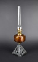 A Late Victorian/Edwardian Cast Iron Based Oil Lamp with Amber Glass Reservoir and Plain Chimney,