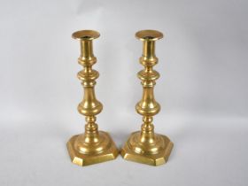 A Pair of 19th Century Brass Candlesticks with Pushers, 30.5cm high