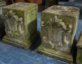 A Pair of Reconstituted Stone Plinth Bases with Shield Motif in Relief, 40cm high