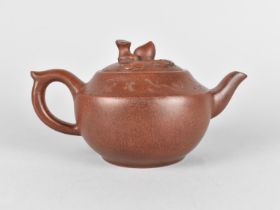 A Chinese Yixing Teapot with Incised Verse, the Lid with Peach Finial, Makers Mark to Lid and Four