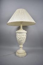 A Moulded Composition Vase Shaped Table Lamp in the Italian Style with Cherub Decoration in