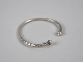 An Ethnic White Metal Bangle, Hammered Decoration and Cone Finials, 21.5gms