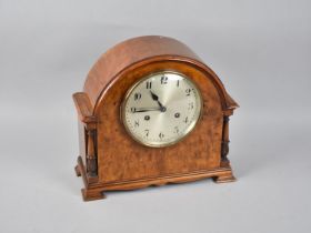 A Mid 20th Century Burr Walnut Arch Topped Mantel Clock with Eight Day Movement and Turned Carved