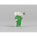 A Cold Painted Miniature Study of Babar the Elephant Modelled Standing with Trunk Carrying Hat,