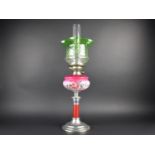 A Late Victorian/Edwardian Oil Lamp with Metal Base, Opaque Pink Glass Reservoir, Green Shade and