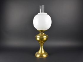 A Brass Oil Lamp with Unrelated Opaque Glass Shade and Unrelated Chimney