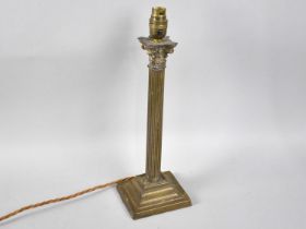 An Edwardian Brass Table Lamp Base in the form of a Reeded Corinthian Coolum, 37cms High