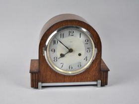 An Art Deco Chrome Mounted Oak Mantel Clock by Enfield, 25cms Wide