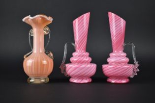 A Pair of Pink and White Swirl Opaque Glass Ewers Together with an Orange and White Swirl Opaque