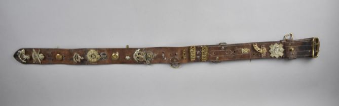 A Leather Belt Mounted with Military Badges and Buttons including Shropshire, Royal Artillery,