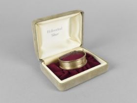 A Cased Silver Napkin Ring with Engine Turned Decoration, Birmingham Hallmark