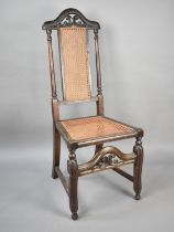 A 19th Century Cane Seated and Backed Oak Framed Side Chair with Pierced and Arched Top Rail