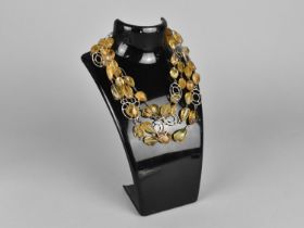 A Long Necklace Comprising Raw and Faceted Citrine Stones with Circular White Metal Framed