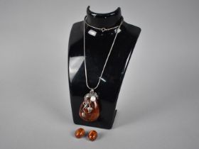 A Large Silver Mounted Faux Amber Pendant on Silver Chain Together with Faux Amber Clip on Earrings