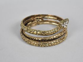 A Jewelled Gilt Metal Jewelled Bangle in the Form of a Coiled Snake
