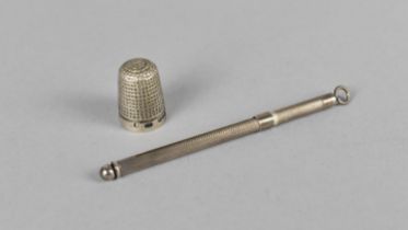 A Silver Swizzle Stick Together with a Silver Thimble