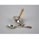 A Silver Mounted Babies Rattle, Birmingham 1928 by FHA &Co, Together with an Inlaid Silver Teaspoon,