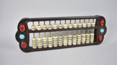 A Reproduction Chinese Abacus with Jewelled and Cabochon Mounts, 42cms Wide