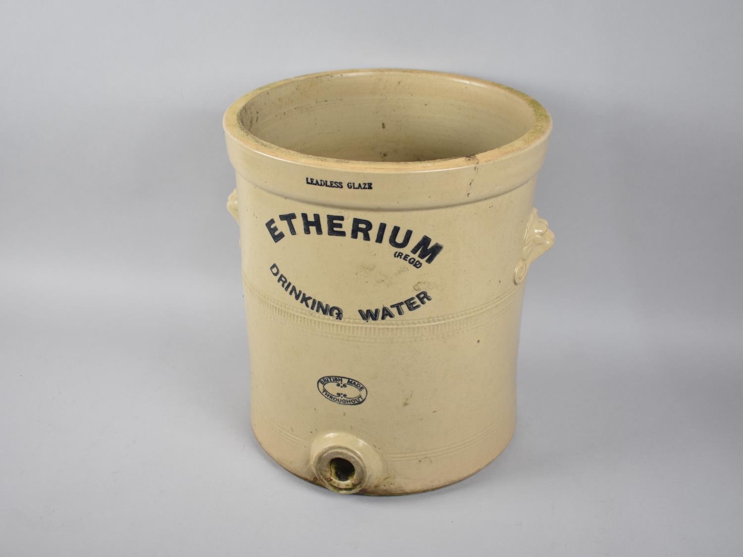A Glazed Stoneware Etherium Drinking Water Filter with two lion Mask Carrying Handles, no Lid or
