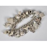 A Heavy Silver Charm Bracelet, Curb Link Chain with 19 Various Charms to include Articulated Egg,