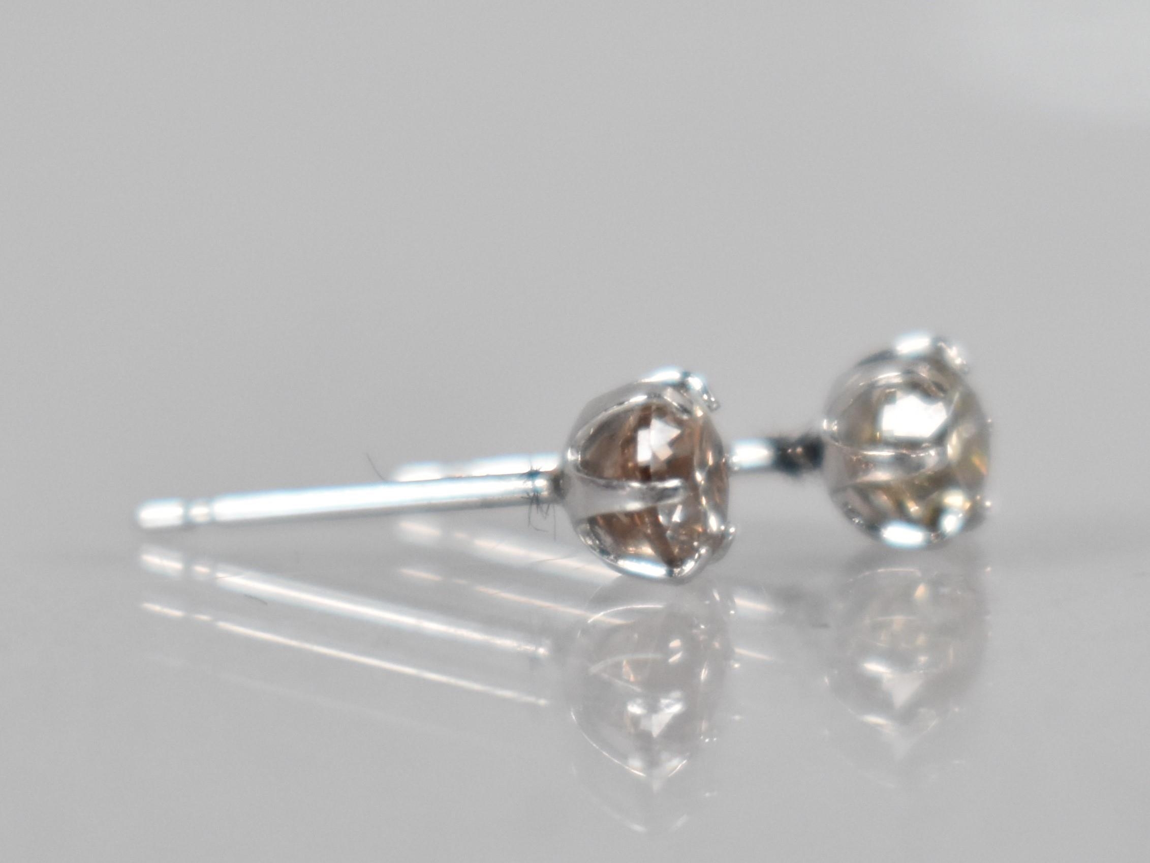 A Pair of Diamond and Platinum Stud Earrings, Round Brilliant Cut Stones Measuring 0.30ct Each (0. - Image 2 of 3