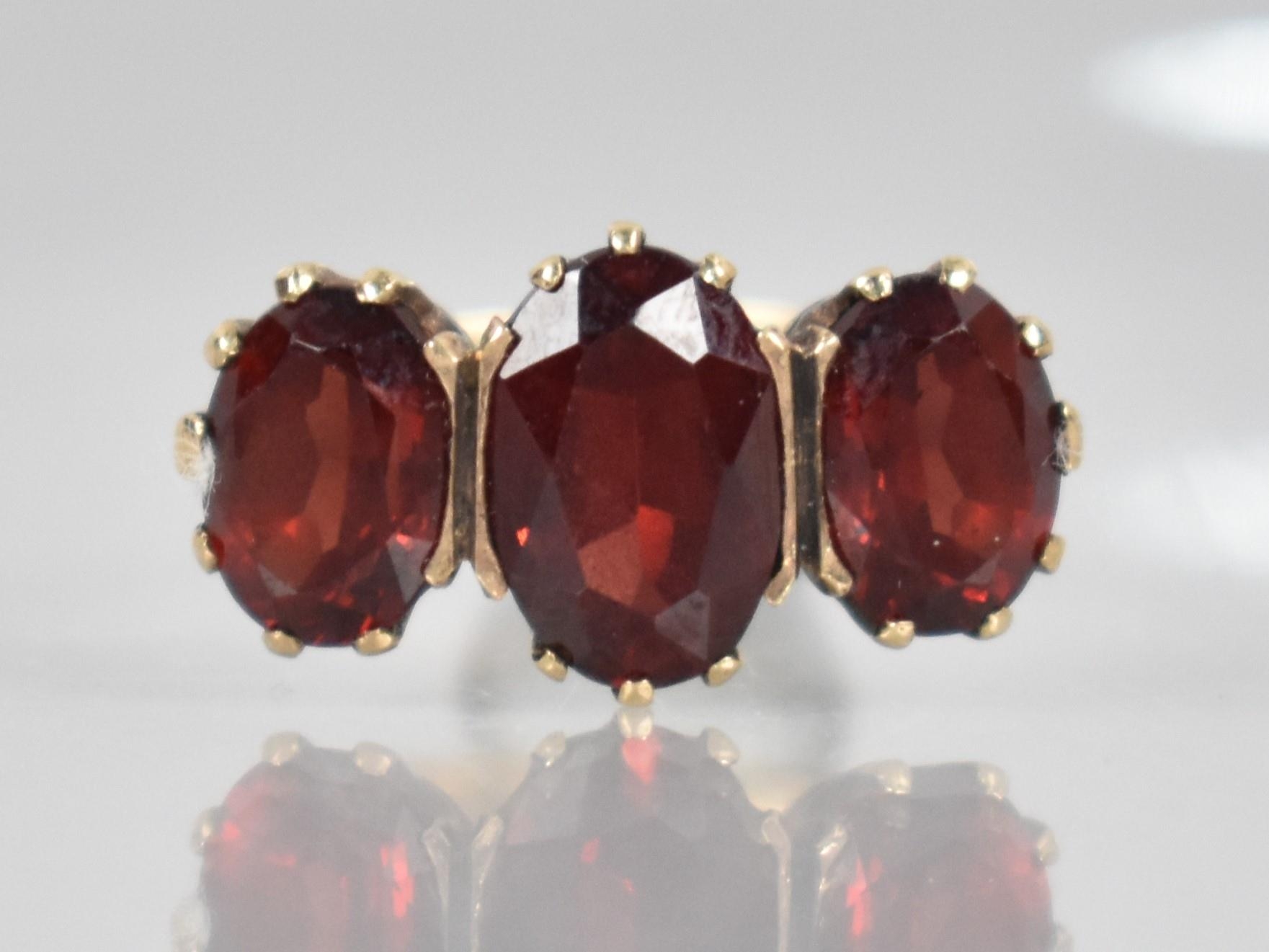 A 9ct Gold and Garnet Dress Ring, Central Oval Cut Stone Measuring 9.9mm by 6.5mm, Claw and