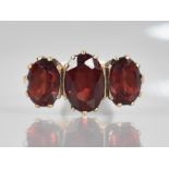 A 9ct Gold and Garnet Dress Ring, Central Oval Cut Stone Measuring 9.9mm by 6.5mm, Claw and