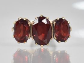 A 9ct Gold and Garnet Dress Ring, Central Oval Cut Stone Measuring 9.9mm by 6.5mm, Claw and