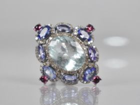 An Aquamarine, Diamond, Tanzanite and Tourmaline Mounted Dress Ring, Central Oval Cut Aquamarine