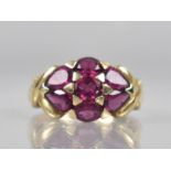 A 9ct Gold and Garnet Cluster Dress Ring Comprising Oval and Pear Cut Garnets, Tension/Pave Set in