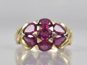 A 9ct Gold and Garnet Cluster Dress Ring Comprising Oval and Pear Cut Garnets, Tension/Pave Set in