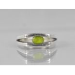 A Heavy Modernist Peridot and Silver Ring with Oval Cut Stone Measuring 5.6mm by 3.3mm, Tension