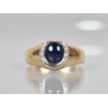 A 9ct Gold and White Metal Cabochon Sapphire Mounted Dress Ring, Central Oval Stone Measuring Approx