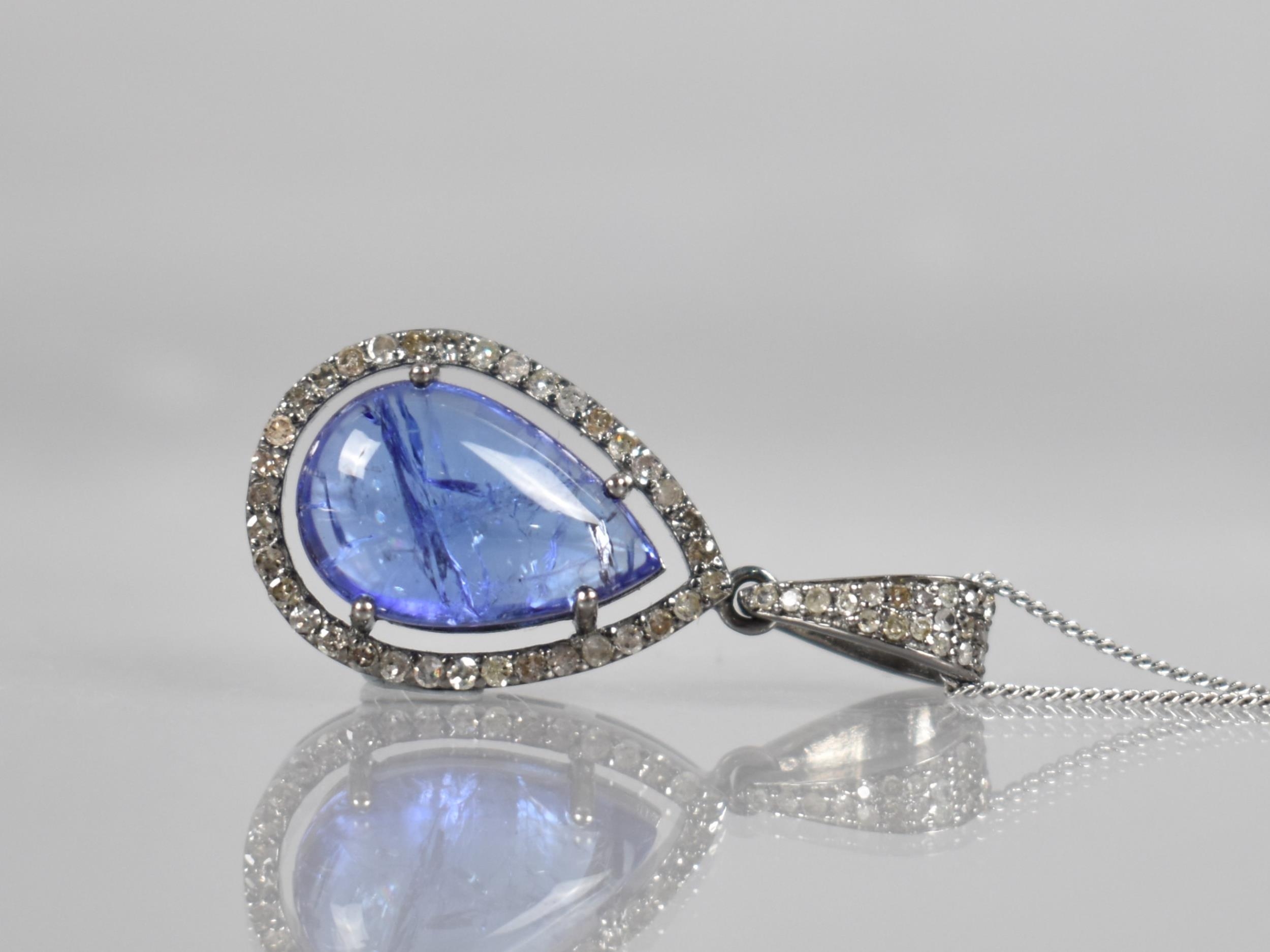 A Tanzanite and Diamond Set Pendant, Central Pear Shaped Cabochon Tanzanite Measuring Approx 4.90ct,