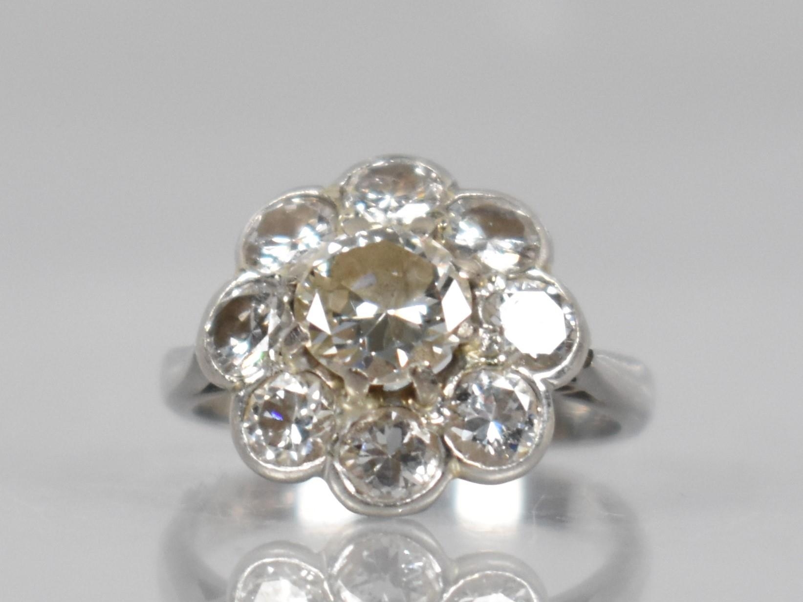 A Platinum and Diamond Daisy Cluster Ring (At Fault), Central Round Cut Diamond Measuring 6.31mm