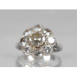 A Platinum and Diamond Daisy Cluster Ring (At Fault), Central Round Cut Diamond Measuring 6.31mm
