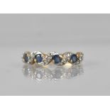 A Sapphire and Diamond 9ct Gold Ladies Dress Ring, Four Round Cut Sapphires Claw and Tension Set
