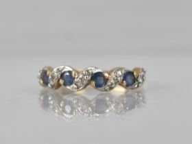 A Sapphire and Diamond 9ct Gold Ladies Dress Ring, Four Round Cut Sapphires Claw and Tension Set