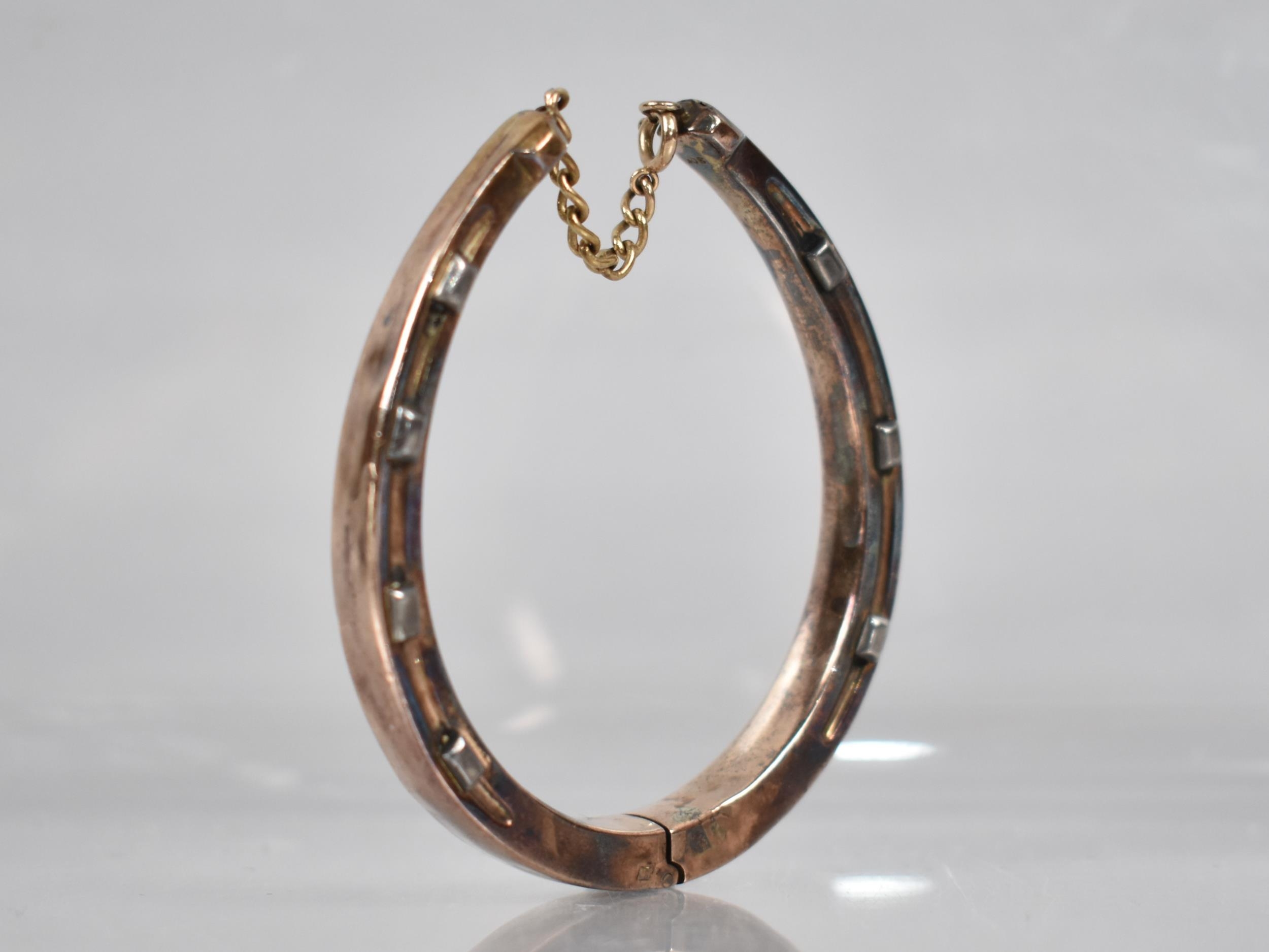 A Hinged Bangle, Horseshoe, Stamped 9ct, 16.5gms, In Leather Case for D&J Wellby Ltd, Garrick