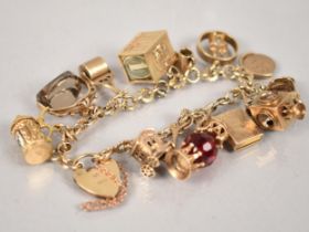 A 9ct Gold Charm Bracelet, 12 Gold Metal Charms, Most Stamped for 9ct, to include Vespa, Lamp,