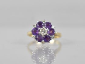 An 18ct Gold, Diamond and Untested Amethyst Ladies Cluster Ring, Central Round Brilliant Cut Diamond